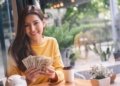person holding money dividend income