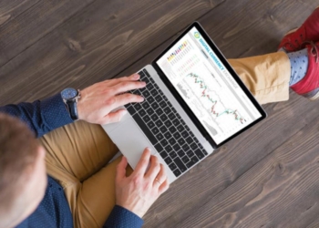 person looking at laptop stock market Getty Images