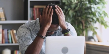 worried man looking at laptop over retirement savings