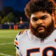 Darnell Wright flexes right elbow at Bears camp